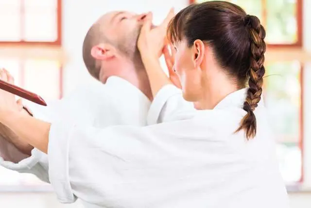adult practicing defense moves for adult martial arts class