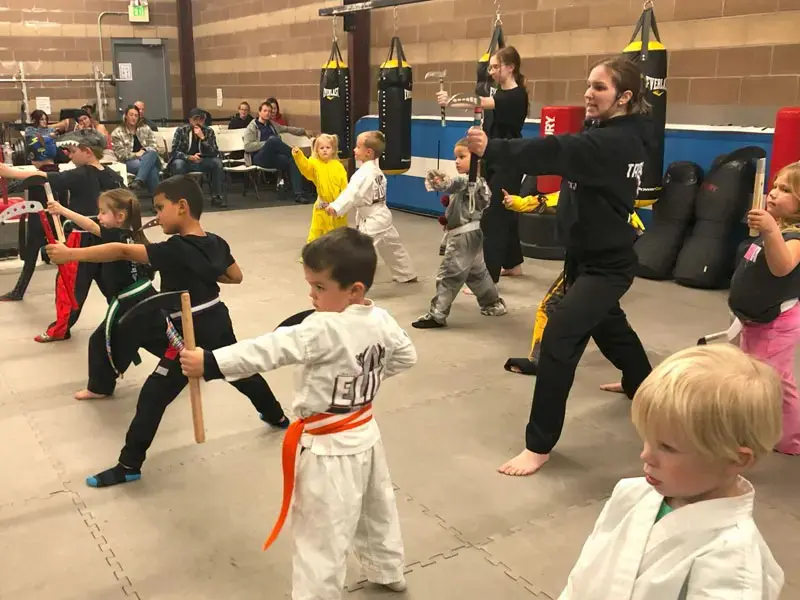 group of toddlers practicing stances for taekwondo lessons